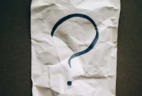 Question mark on white paper
