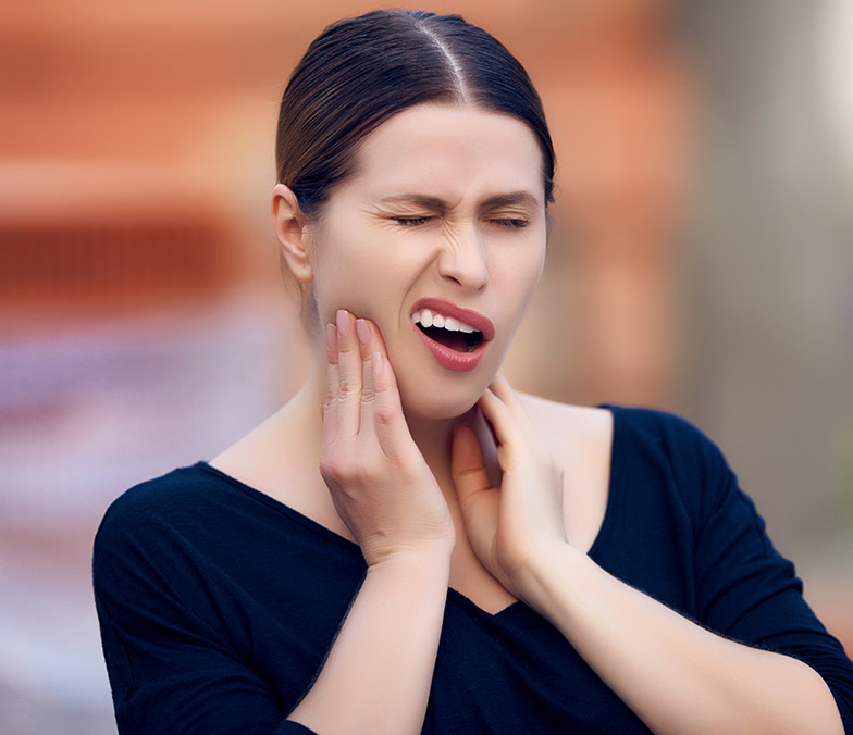 Woman's face contorting in pain from teeth