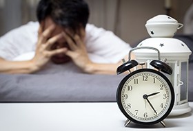 tired man staring at the clock