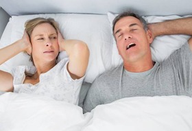 Man snoring, wife blocking ears