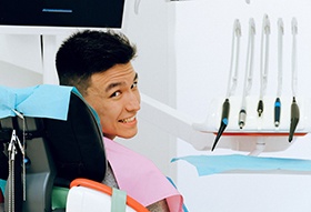 Smiling male patient in dentist’s chair