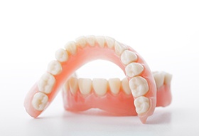 A set of full dentures sitting on a white background