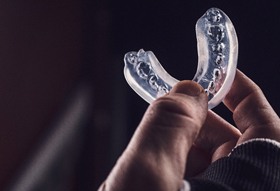 Close-up of hand holding an athletic mouthguard