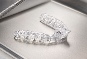 clear braces lying on metal tray