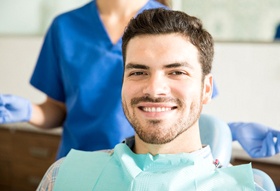 Male dental patient smiling after TMJ treatment in Longview, TX